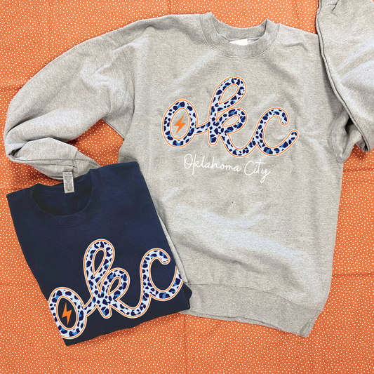 OKC SPIRIT: OKC Script Blue Leopard (SWEATSHIRT)